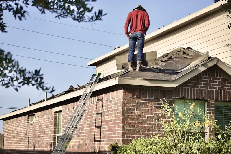 Professional roofer working on a residential roof in Frontier Park